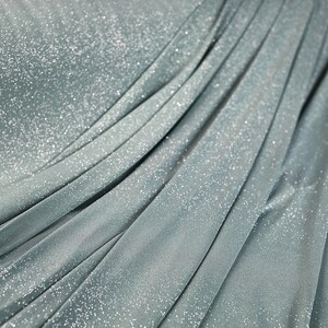 a close-up view of a shiny, metallic fabric with a textured, crumpled appearance.