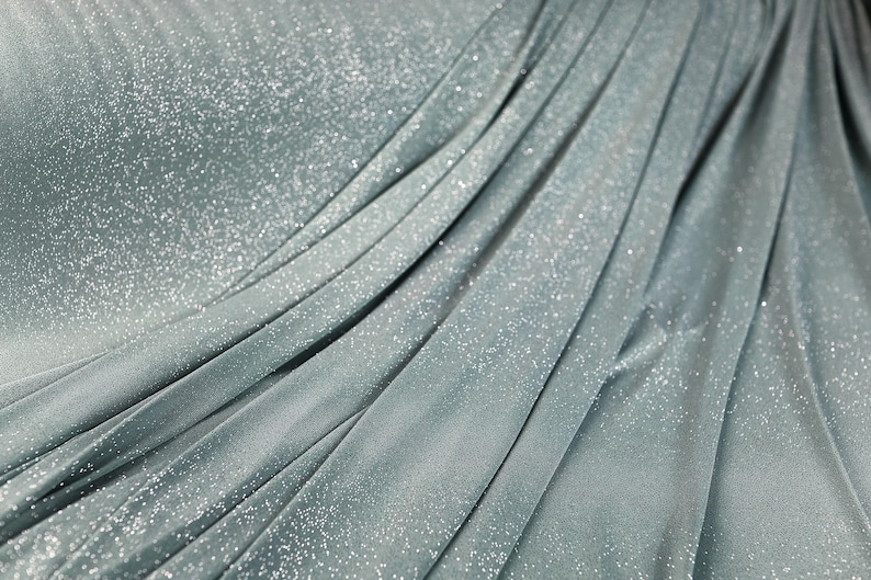 a close-up view of a shiny, metallic fabric with a textured, crumpled appearance.