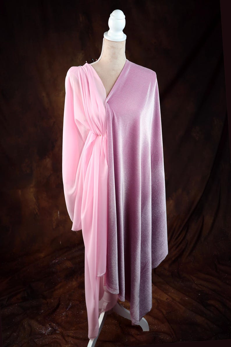 A mannequin wearing a pink satin dress with a draped, flowing skirt.