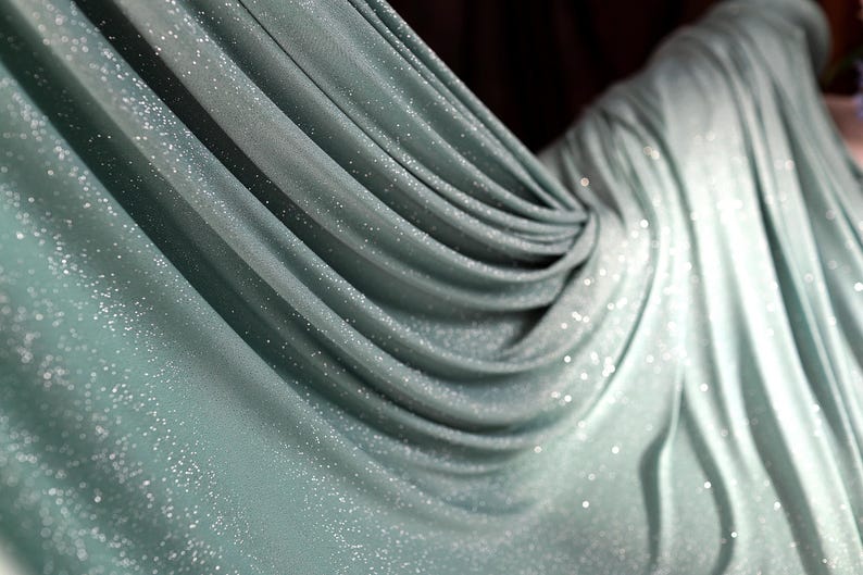 a close-up view of a shiny, metallic fabric with a sparkling texture.