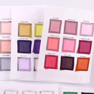 a collection of fabric swatches, each displaying a different color. The swatches are arranged in a grid format, with each row representing a different color and each column representing a different swatch. The swatches are spread across a surface, and there are several of them visible in the image.