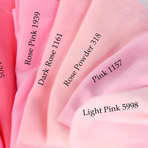 a close-up view of a collection of pink fabric swatches, each with a different shade and label indicating the color.