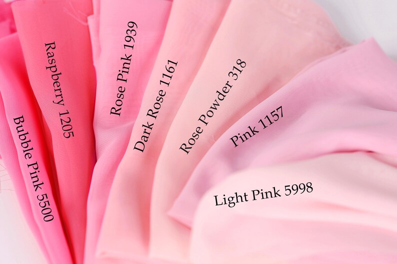 a close-up view of a collection of pink fabric swatches, each with a different shade and label indicating the color.