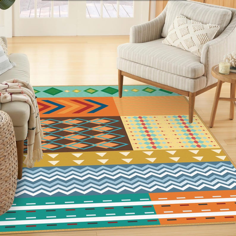 May include: A rectangular area rug featuring a multi-colored geometric pattern. The design includes horizontal bands of teal, orange, yellow, and brown, decorated with various shapes such as chevrons, diamonds, triangles, and dashed lines.