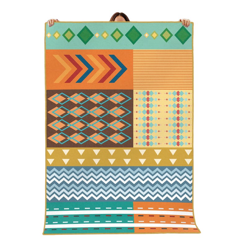 May include: A rectangular throw blanket featuring a multi-colored geometric pattern. The design includes horizontal bands of diamonds, chevrons, stripes, triangles, and zigzags in shades of teal, orange, brown, yellow, and light blue with a gold border.