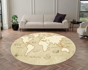 May include: A round area rug featuring a vintage-style world map in shades of beige and cream. The design includes illustrations of historical sailing ships and sea creatures, along with a compass rose and labeled ocean names in dark ink.