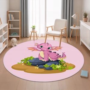 May include: A round pink rug featuring a cartoon dragon. The dragon is purple with green eyes, sitting on a dark blue rock with green foliage. The rug is in a room with a window, chair, and shelves.
