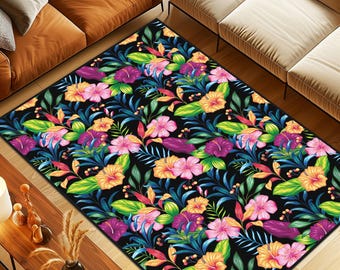 May include: A rectangular area rug featuring a dense, repeating pattern of vibrant hibiscus flowers in shades of pink, purple, and yellow, interspersed with lush green and blue tropical foliage against a solid black background.