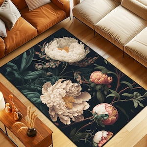 May include: A rectangular area rug featuring a dark black background adorned with large, detailed white and soft pink peony flowers, green leaves, and brown stems. The floral pattern is distributed across the surface in a botanical arrangement.