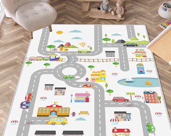 May include: A rectangular area rug featuring a white background with a colorful printed city map. The design includes gray roads, a roundabout, various buildings, trees, vehicles, a train, a lake with a sailboat, and a bright yellow sun.
