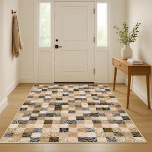 May include: A rectangular rug with a patchwork design. The rug features rectangular blocks in beige, brown, black, and white. Some blocks have a textured, linear design. The rug is placed in a hallway, likely in a home.