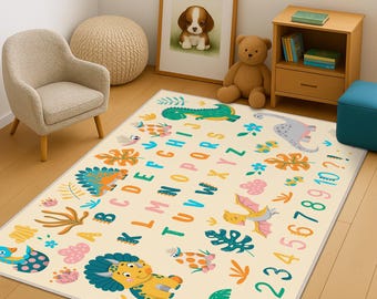 May include: A rectangular area rug with a cream background featuring a colorful dinosaur theme. The design includes the alphabet in capital letters, numbers one through ten, and various illustrations of dinosaurs, palm trees, and tropical leaves.