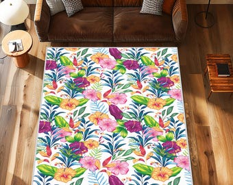 May include: A rectangular area rug with a vibrant floral pattern. The rug features a white background with colorful flowers in shades of pink, yellow, and purple, along with green leaves. The rug is placed on a wooden floor.