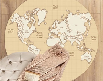 May include: A beige round rug with a world map printed on it. The map is in a vintage style with brown outlines and mountains represented by small triangles. The rug is on a wooden floor with a throw blanket and a cup of coffee on a small ottoman.