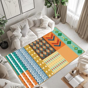 May include: A rectangular area rug featuring a vibrant patchwork design with geometric patterns including chevrons, diamonds, zigzags, and stripes in a palette of orange, teal, brown, yellow, and light blue, finished with a thin tan border.