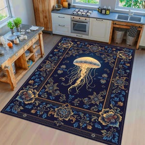 May include: A rectangular area rug featuring a dark navy blue background with a central golden jellyfish illustration. The rug is decorated with a symmetrical border of intricate floral patterns in shades of blue, gold, and cream, framed by a geometric line.
