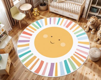 May include: A round, white play mat with a colorful sun design. The sun has a smiling face and is surrounded by rainbow stripes.