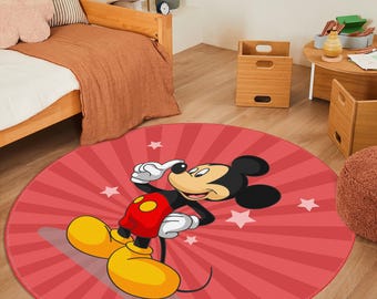 May include: A round area rug featuring a red background with a sunburst pattern and white stars. Mickey Mouse is centered on the rug, wearing red shorts, white gloves, and large yellow shoes, with a black body and a tan face.