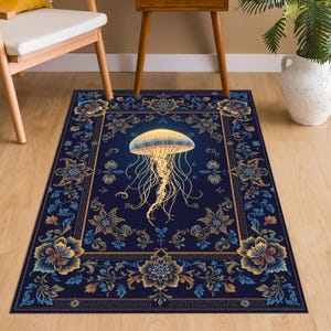 May include: A rectangular area rug featuring a deep navy blue background with a central glowing yellow jellyfish illustration. The border displays intricate floral patterns in shades of gold, light blue, and dark blue, framed by a geometric Greek key design.