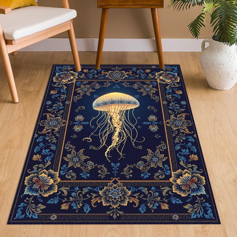 May include: A rectangular area rug featuring a deep navy blue background with a central glowing yellow jellyfish illustration. The border displays intricate floral patterns in shades of gold, light blue, and dark blue, framed by a geometric Greek key design.