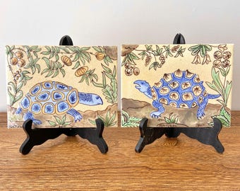 Set of 2 Vintage Hand-Painted Portugal Art Tiles with Blue Turtle Motif, Botanical Detail, Signed Bert, Beige Ceramic Wall Decor