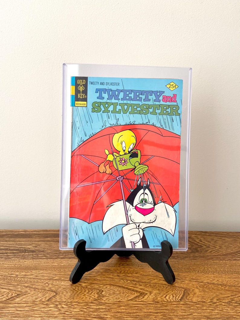 May include: A vintage comic book featuring Tweety Bird and Sylvester the Cat. The cover shows Tweety Bird holding a watering can and Sylvester the Cat holding a red umbrella. The comic book is titled "Tweety and Sylvester" and has a price of 25 pence.