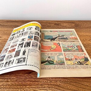 May include: A vintage comic book featuring Tweety Bird and Sylvester the Cat. The cover features a black and white illustration of Tweety Bird and Sylvester the Cat in a train carriage. The comic book is titled "The Great Train Robbery".