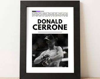 May include: Black framed print featuring a black and white photo of Donald Cerrone, a professional mixed martial artist, wearing a cowboy hat. The print includes the name "DONALD CERRONE" in large, bold letters.