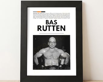 May include: Black framed print featuring a black and white photo of Bas Rutten, a mixed martial artist. The print includes the name "BAS RUTTEN" in large, bold letters and biographical text. The image is set against a white background.