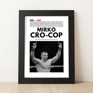 May include: Black framed print featuring a black and white image of Mirko Cro-Cop with his arms raised. The print includes text with the name "Mirko Cro-Cop" in large, bold letters, and biographical information.