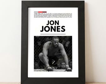 May include: A framed black and white print featuring the name "JON JONES" in bold, black letters. Below the text is a black and white photo of a man in a fighting stance. The print includes biographical text about Jon Jones.