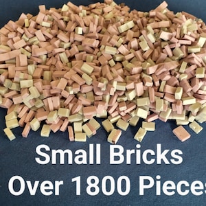 May include: A large pile of over 1800 small, rectangular bricks in beige and pink colors.  Small Bricks Over 1800 Pieces