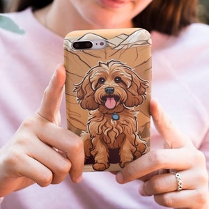 May include: A phone case with a cartoon illustration of a brown and white dog with a blue collar. The dog is sitting on a brown and white background.