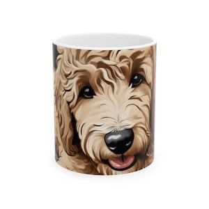 May include: A white ceramic mug with a brown and white doodle dog illustration. The dog has brown eyes and a pink tongue.