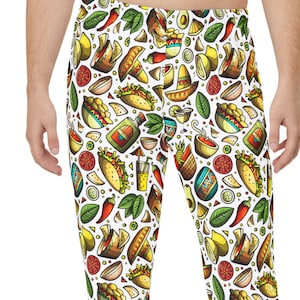 May include: White lounge trousers featuring a colourful repeating pattern of Mexican-themed illustrations including tacos, sombreros, chilli peppers, lime wedges, bowls of salsa, and bottles of hot sauce distributed across the entire fabric surface.