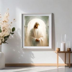 May include: A painting of Jesus Christ wearing a white robe, standing in a light-filled room with pillars. The painting is framed in a white frame and hangs on a white wall.