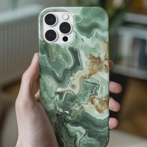 May include: A green and brown marble-patterned phone case. The case has a glossy finish and covers the back and sides of a smartphone. The case has cutouts for the camera and buttons. The phone case is held in a person's hand.