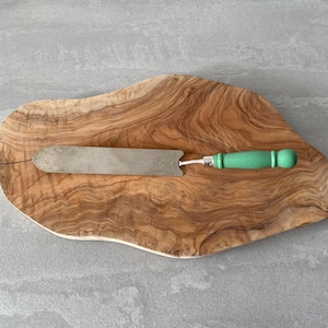 Vintage metal spatula with wooden green handle