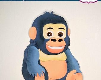 May include: A die-cut papercraft of a cartoon gorilla with a smiling expression. The gorilla is primarily blue, with tan and peach accents. The text "My Cut & Paste Die Cuts" and "Scrapbooking Embellishments" are at the top.