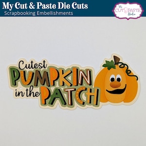 May include: A die cut featuring a smiling pumpkin with the text "Cutest Pumpkin in the Patch". The pumpkin is orange with a green stem and leaves. The text is in brown, orange, and green.