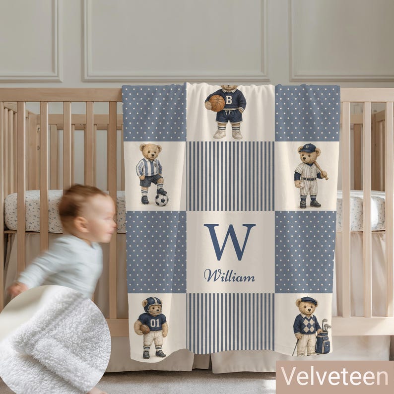 May include: A blue and white baby blanket featuring a grid pattern with polka dots and stripes. The design includes illustrations of teddy bears dressed in various sports uniforms, along with the letter W and the name William printed in blue.