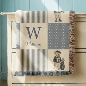 Vintage baby boy nursery blanket with teddy bears in classic sports outfits and custom monogram name design in neutral blue tones.