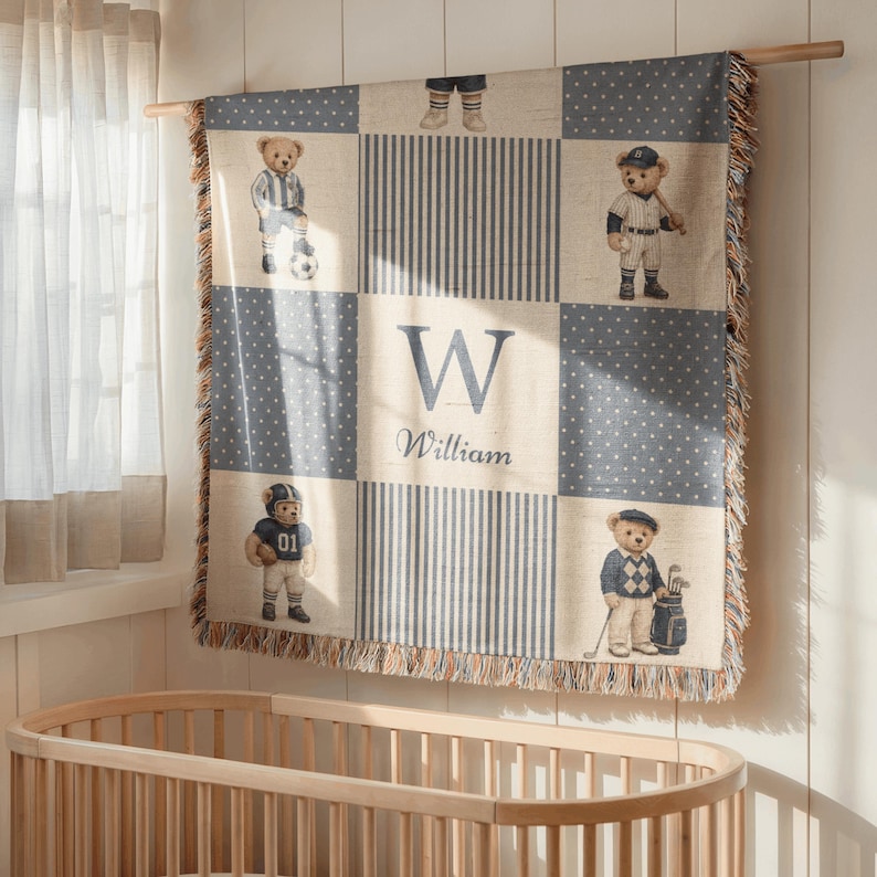 May include: A woven throw blanket featuring a patchwork design with blue and white polka dots and stripes. The blanket displays four teddy bears dressed in sports attire and a central panel with the letter W and the name William in blue text.