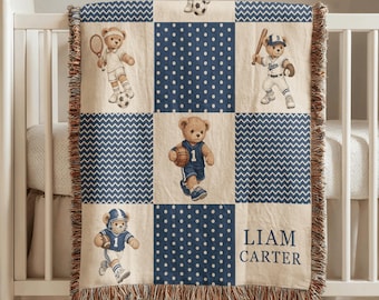 May include: A woven throw blanket featuring a grid pattern of cream and navy blue squares. The design includes illustrations of teddy bears playing various sports, navy blue polka dot squares, and chevron patterns. The text reads LIAM CARTER.