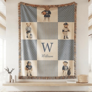 Vintage baby boy nursery blanket with teddy bears in classic sports outfits and custom monogram name design in neutral blue tones.