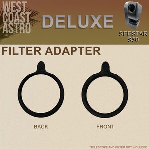 May include: Two black circular filter adapters for a Seestar S50 telescope, labeled as back and front. The text reads West Coast Astro Deluxe Filter Adapter. The adapters feature a small tab at the top for handling and a textured finish.
