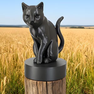 May include: A black cat statue sits atop a black circular base, perched on a weathered wooden post. The cat is in a seated position with its tail curled. The background features a field of wheat under a blue sky.