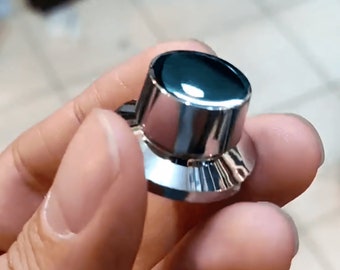 May include: A shiny silver knob with a smooth, rounded top and a textured, ridged base.
