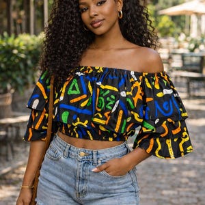 May include: A white ceramic mug with a black handle and the text "But First, Coffee" in a black, handwritten-style font. The mug is on a white surface.