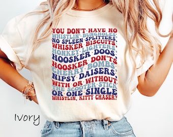 May include: A white t-shirt with a blue and red graphic print that says "You don't have no whistlin' bungo holes, no spleen splitters, whisker biscuits, honkey lighters, hoosker doos, hoosker don'ts, cherry bombs, nipsy daisers, with or without the scooter stick or one single whistlin, kitty chaser?"